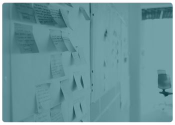 teal tinted image of sticky notes on a board